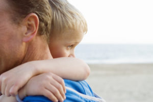 Child with father. Divorce and family lawyers can help mothers and fathers maintain custody of their children.
