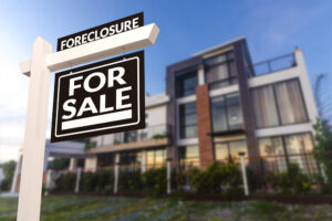 Black Foreclosure Home For Sale Real Estate Sign in front of a home