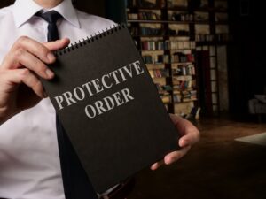lawyer holding a restraining order notebook